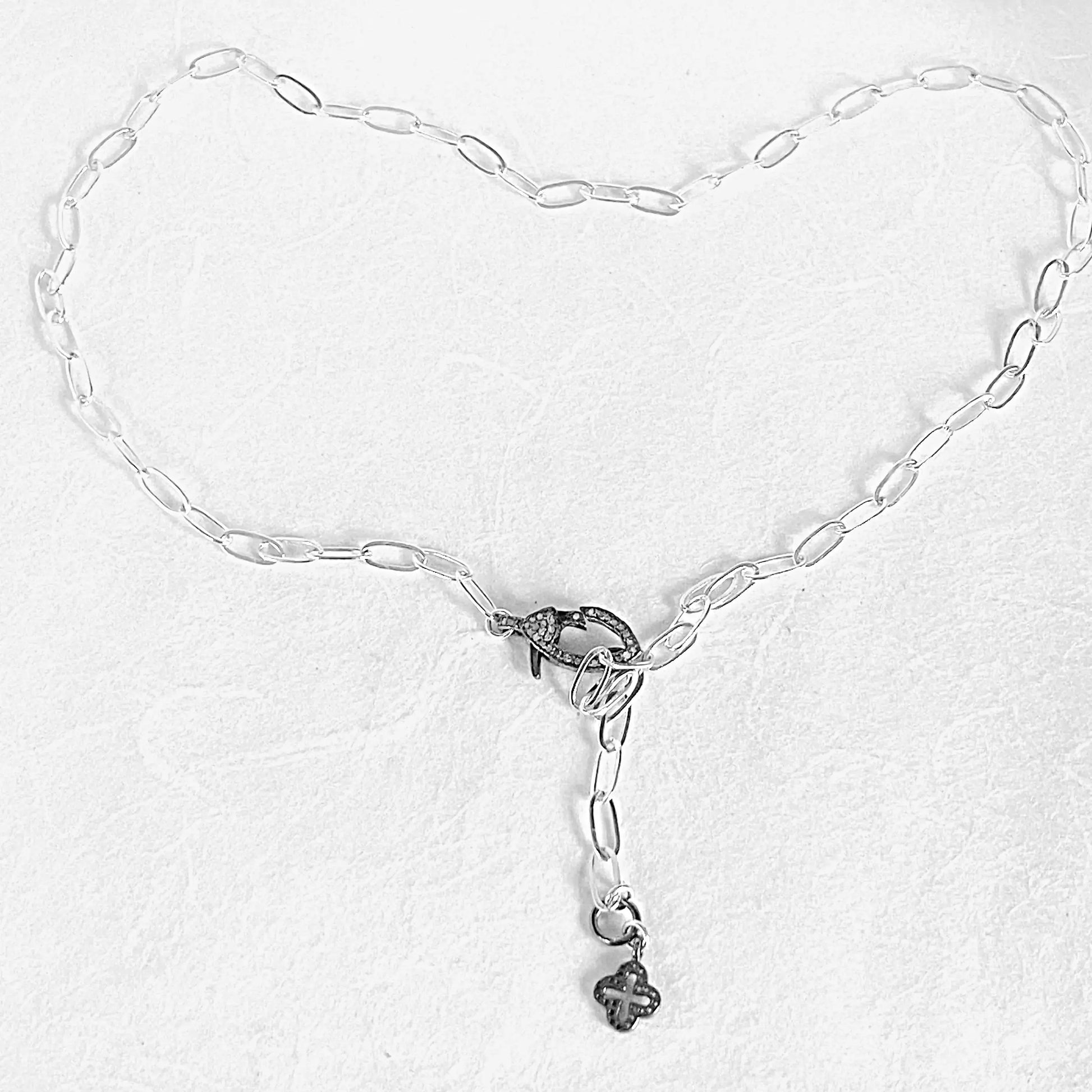 Full view of paperclip chain necklace with moonstone clasp and antiqued silver charm, adjustable up to 19 inches for custom styling.