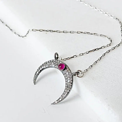 Moonstone ruby necklace with crescent moon pendant in antique sterling silver, featuring pave set moonstone and ruby on 16'' chain.
