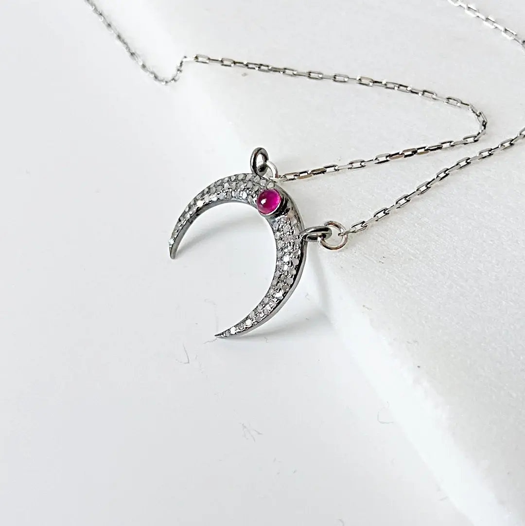 Sterling silver moonstone ruby necklace with crescent moon design, featuring pave set moonstone and ruby on a 16'' antique chain.