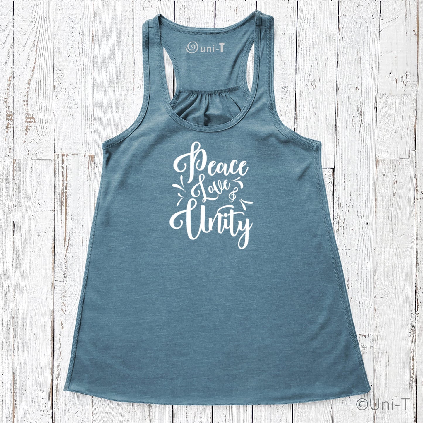 Blue "Peace Love Unity" Tank Top - Embrace Harmony featuring white lettering, displayed flat on a white wood background.