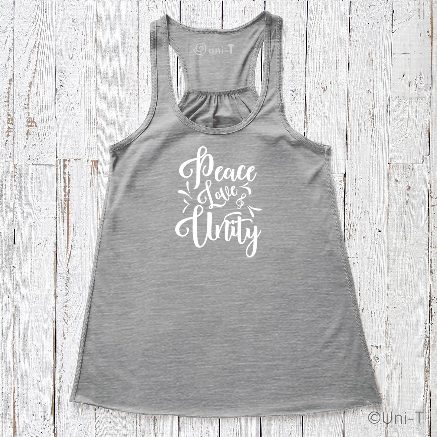 Gray "Peace Love Unity" Tank Top - Embrace Harmony with white print, racerback cut, laid flat on a textured white wood surface.
