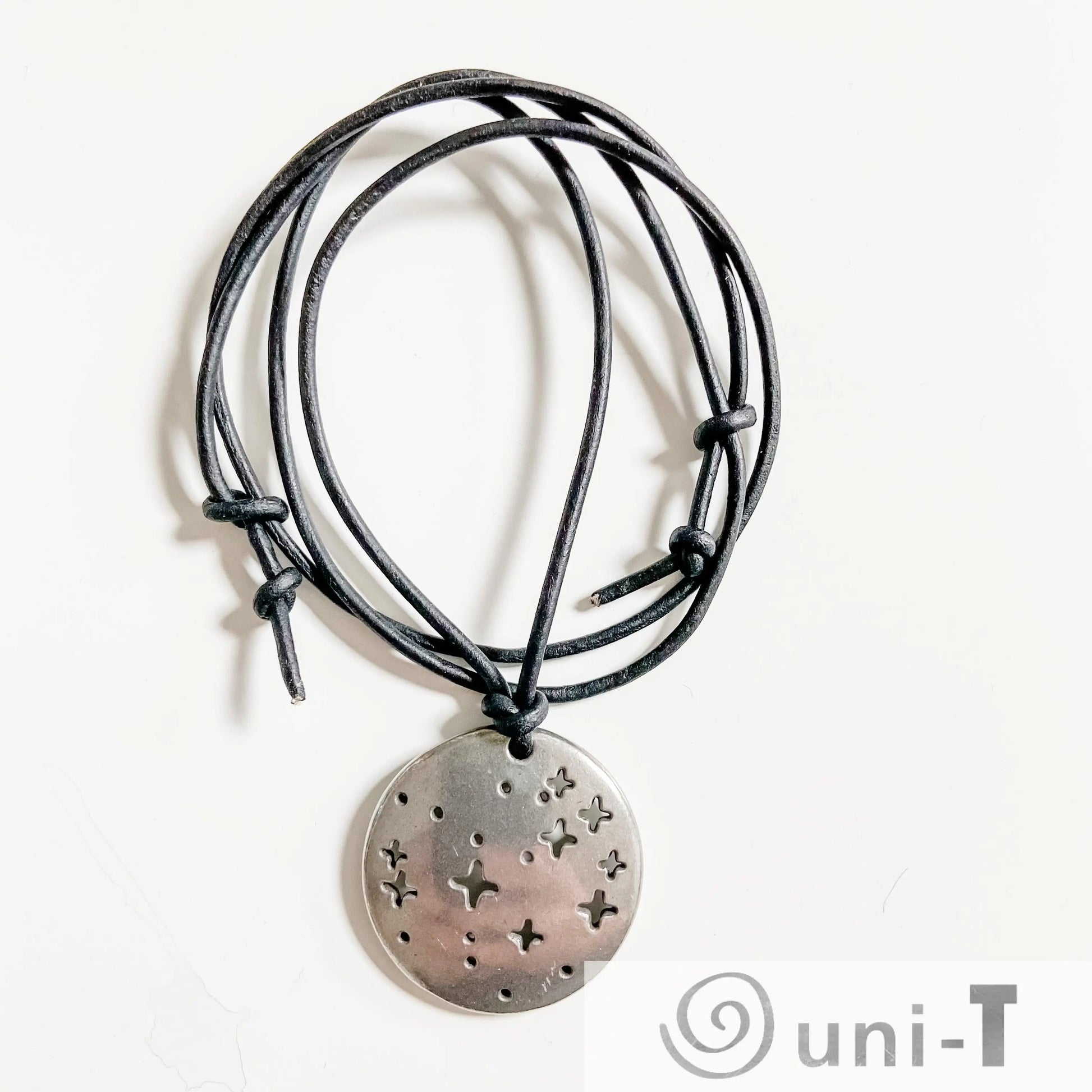 Pleiades Pendant - Pleiades Constellation Necklace with black cord and star cutouts. Ideal science jewelry for astronomy lovers and stargazers.