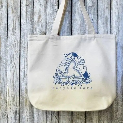Eco-friendly canvas tote with 'Recycle More' artist design in blue on organic cotton. Ideal for sustainable shopping and green lifestyle use.