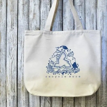 Eco-friendly canvas tote with 'Recycle More' artist design in blue on organic cotton. Ideal for sustainable shopping and green lifestyle use.