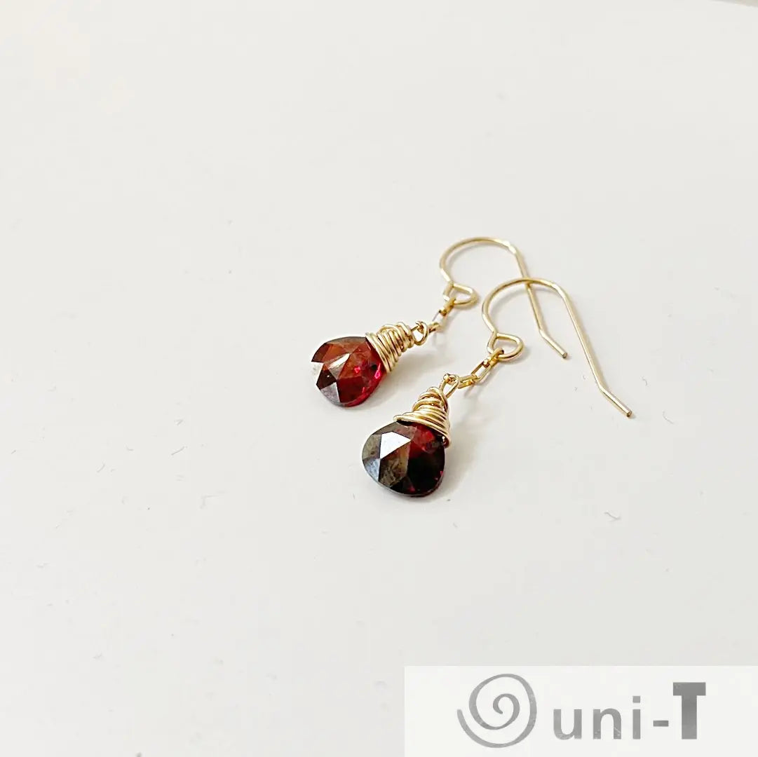 Gold-filled earrings with red teardrop CZ stones, wire-wrapped and lightweight. Stylish 1 inch long dangle design for versatile wear.