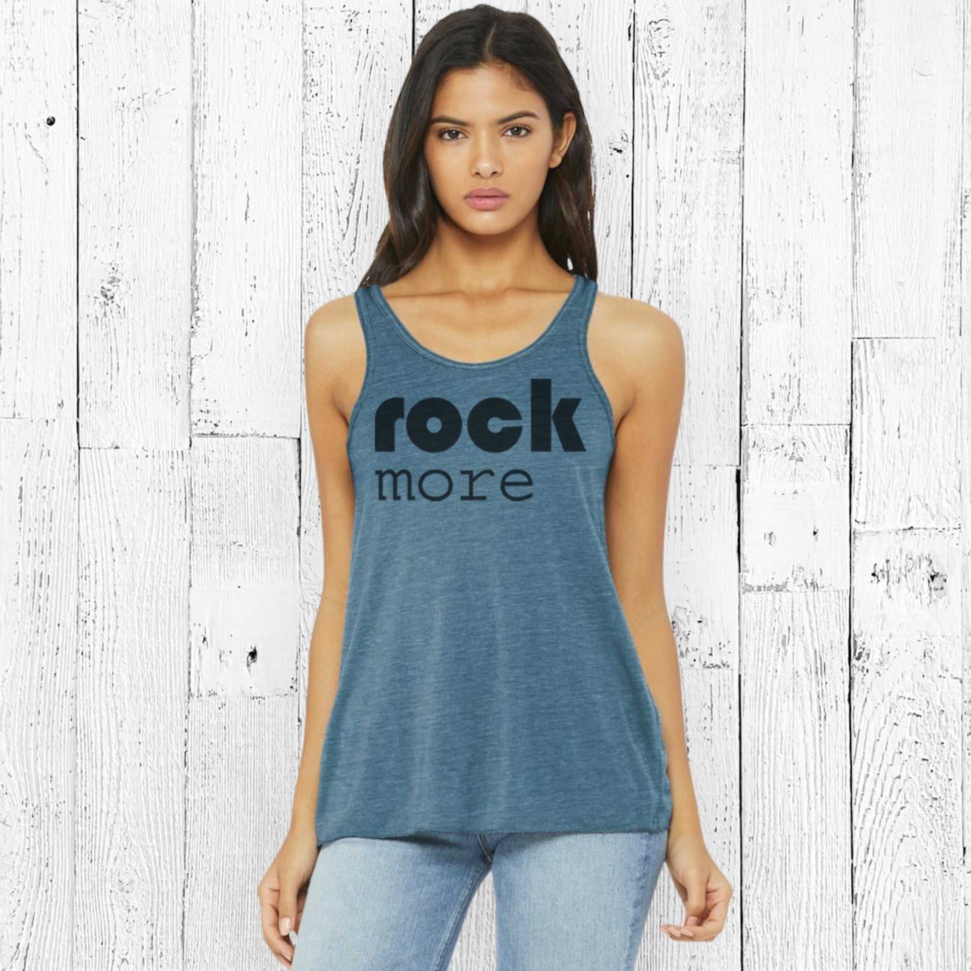 Model wearing teal Rock More Women's Flowy Tank Top with black print, showcasing racerback cut and soft eco-friendly fabric for casual style.