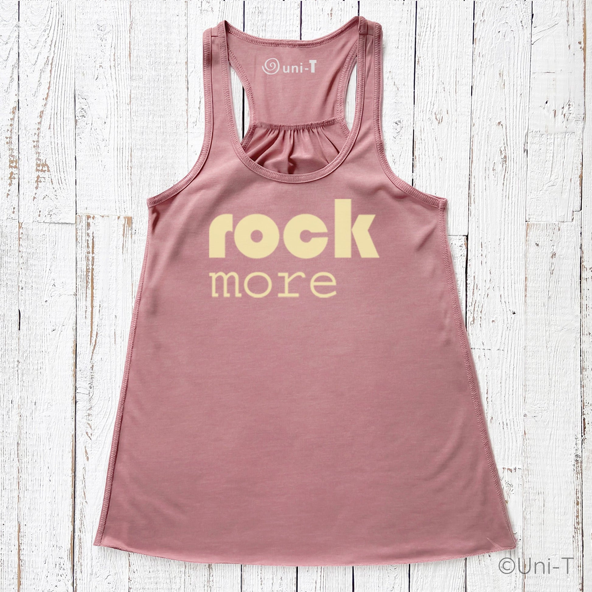 Blush pink Rock More Women's Flowy Tank Top with cream print, eco-friendly soft fabric and racerback design, perfect for stylish comfort.
