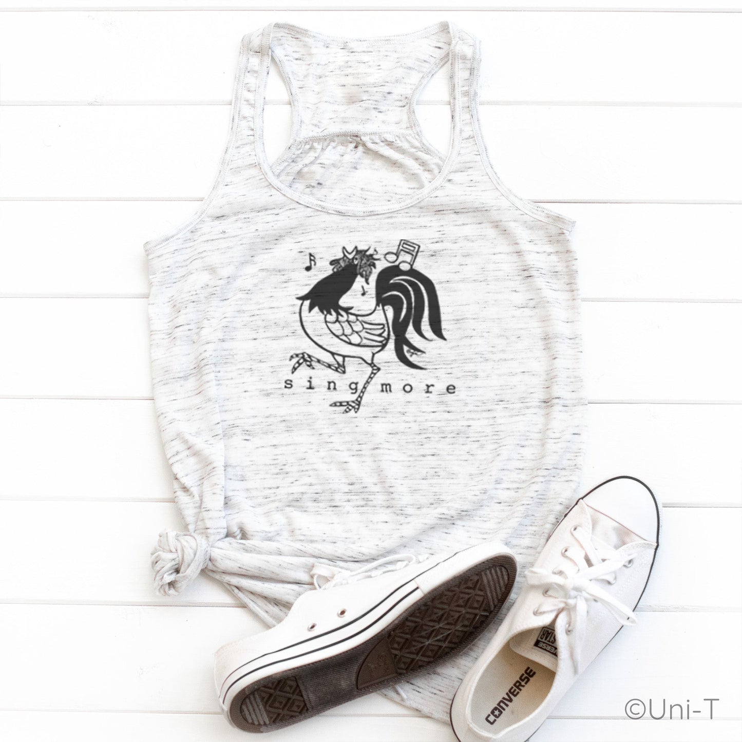 White speckled Rooster Flowy Tank Top - Sing More with black rooster print, styled with sneakers for a casual, confident vocal expression look.