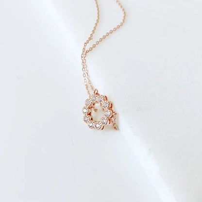 Rose Gold Circle Necklace with cubic zirconia charm on adjustable 18in silver chain, displayed on white background for elegant accessory appeal.