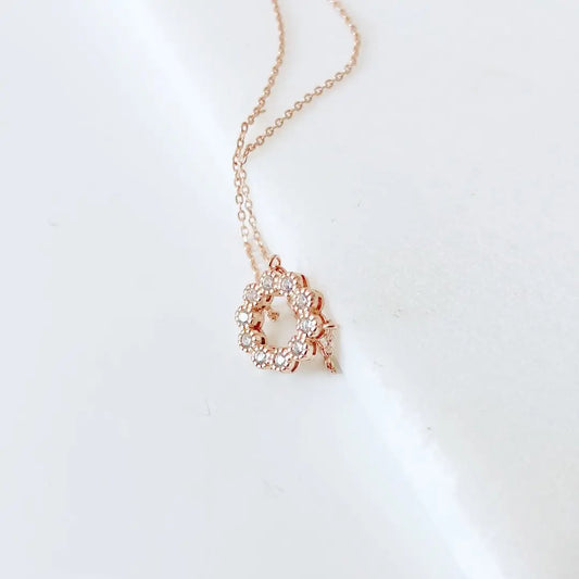 Rose Gold Circle Necklace with cubic zirconia charm on adjustable 18in silver chain, displayed on white background for elegant accessory appeal.