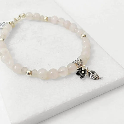 Sterling Silver Charms on Rose Quartz Silver Flower Bracelet featuring soft pink beads and detailed floral charm. Ideal for stylish gifting.