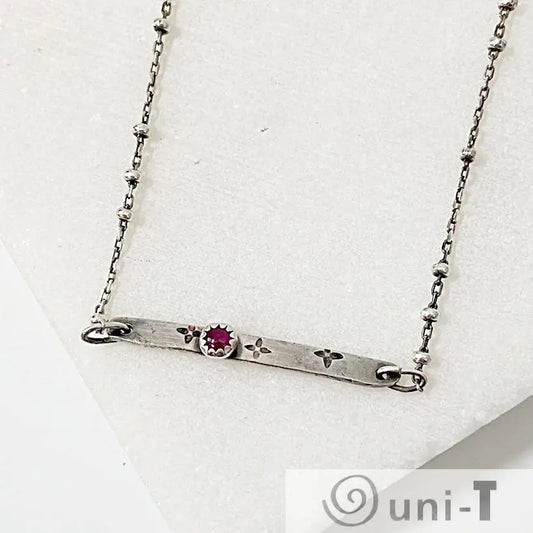 Ruby Silver Bar Necklace with 3mm Ruby Zoisite set in a flower-stamped bar on a 17-inch satellite chain. Modern gemstone necklace for women.