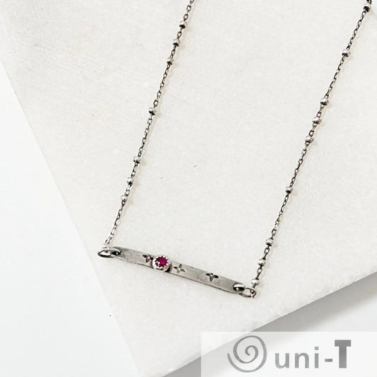 Modern Ruby Zoisite Silver Bar Necklace featuring a dainty satellite chain and floral stamped bar design. Elegant accessory for any outfit.