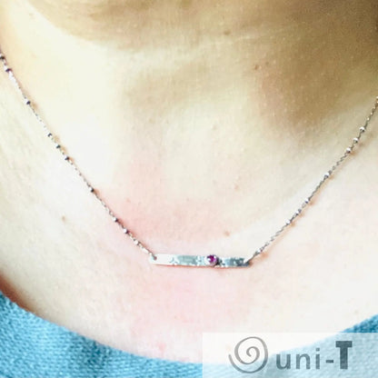Ruby Silver Bar Necklace worn on neck, showcasing minimalist design with gemstone accent. Ideal modern jewelry for daily or special occasions.