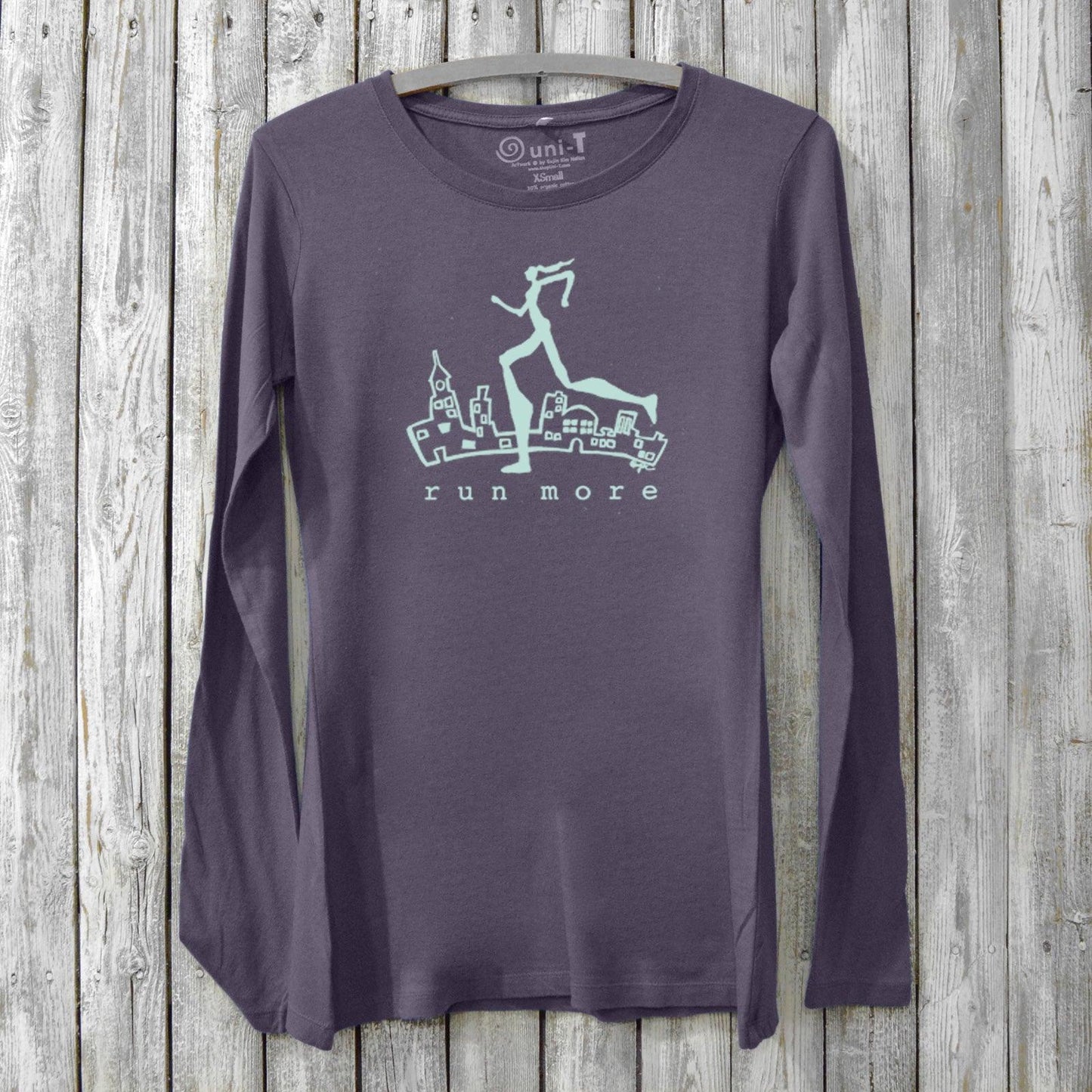 Run More Long Sleeve T-Shirt Women in dark purple with cityscape and runner graphic. Bamboo organic cotton activewear for running and fitness.