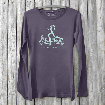 Run More Long Sleeve T-Shirt Women in dark purple with cityscape and runner graphic. Bamboo organic cotton activewear for running and fitness.