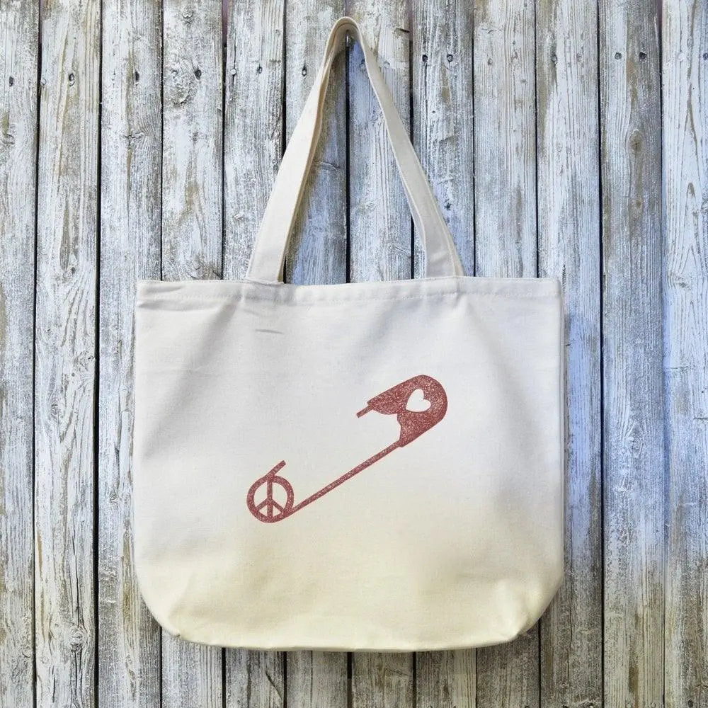 Sustainable Unity Gift Tote Bag in organic cotton with red safety pin artwork symbolizing peace and unity, handcrafted in Massachusetts.