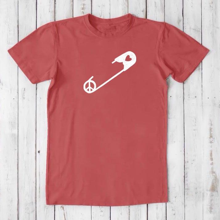 Red men's 'Safety Pin Ally' t-shirt in bamboo & organic cotton with white peace and heart pin graphic. Bold statement tee for proud allies.