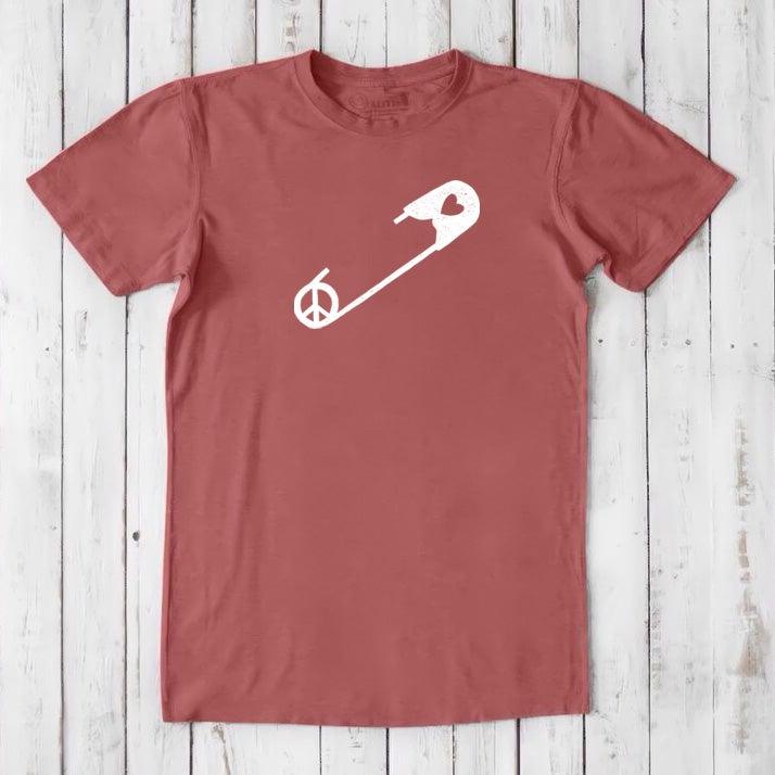 Red clay men's bamboo & organic cotton t-shirt with white safety pin and peace sign. Sustainable graphic tee for allyship and human rights.