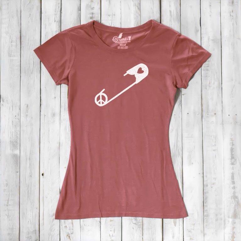 Dusty rose Women's Peace & Love T-Shirt with white safety pin and heart design. Organic cotton blend top for solidarity and activism.