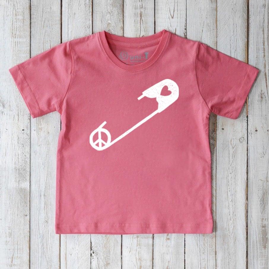 Pink Kids' Safety Pin Organic Cotton T-Shirt featuring white peace and heart graphic, a soft, sustainable top promoting kindness by Uni-T.