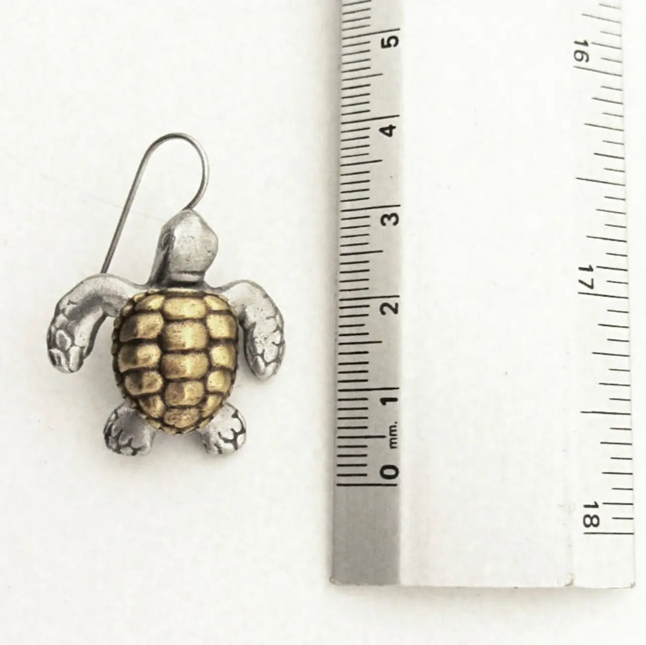 Sea Turtle Earring next to ruler showing 2.5cm size. Loggerhead Turtle design in pewter and brass, perfect lightweight turtle jewelry piece.