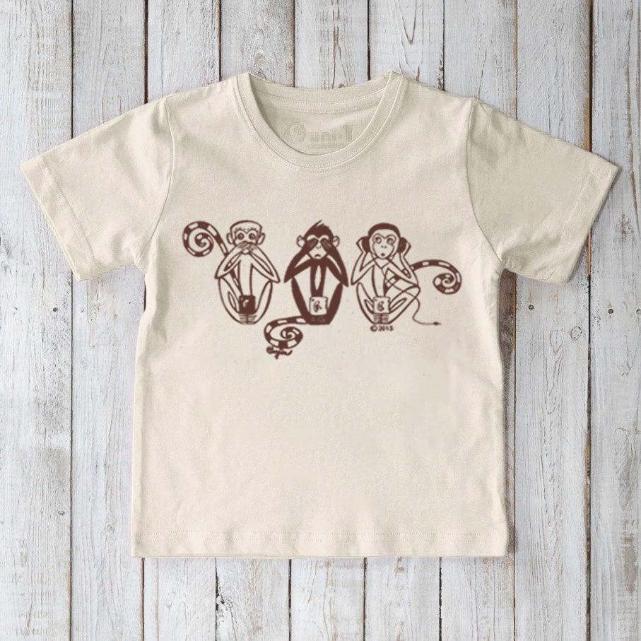 Kids' Three Wise Monkeys Organic Cotton T-Shirt in cream with playful 'See No Evil, Hear No Evil, Speak No Evil' monkey graphic. Eco-friendly fun top.