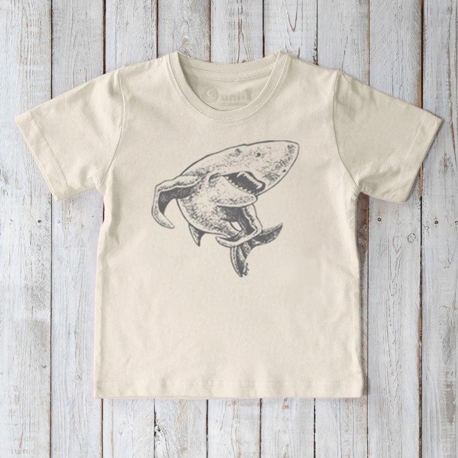 Kids' Shark Organic Cotton T-Shirt in cream featuring a grey shark graphic. Sustainable animal lover top for children by Uni-T.