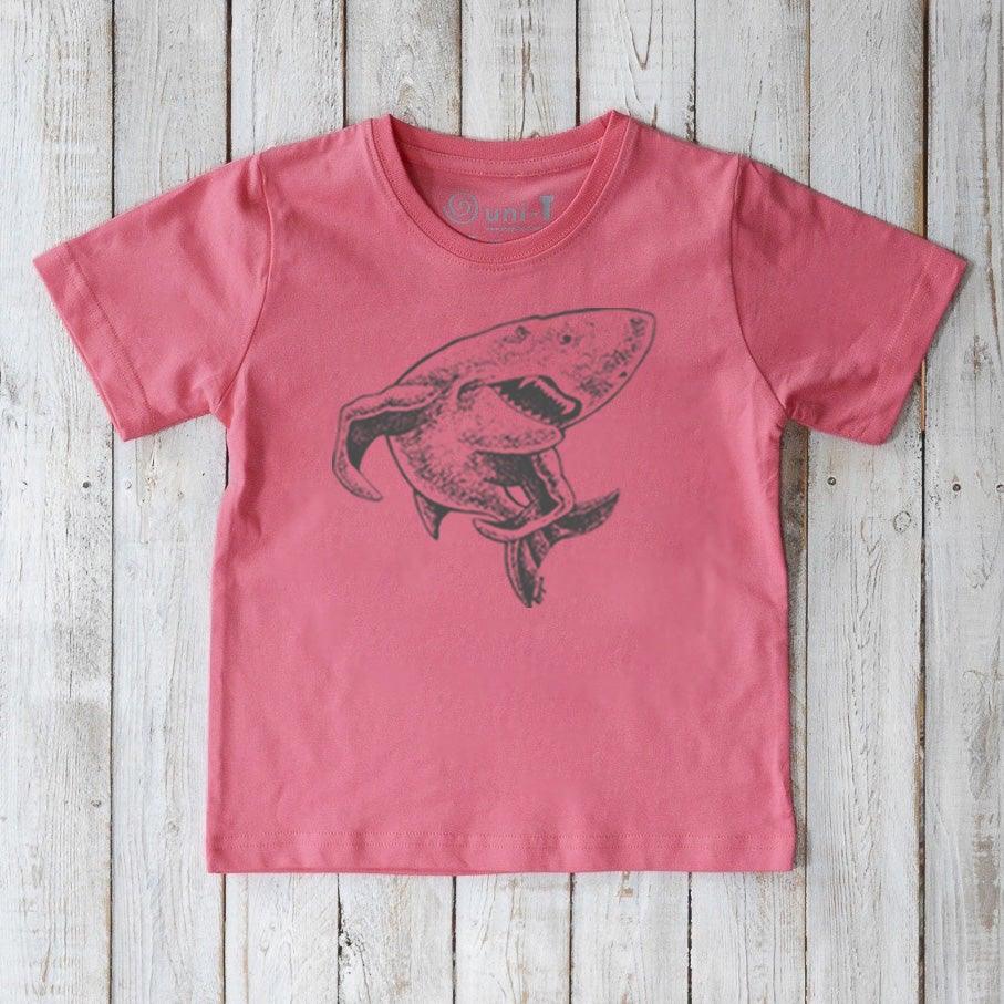 Kids' Shark Organic Cotton T-Shirt in coral pink with black shark design. Ocean-themed sustainable shirt for children by Uni-T.