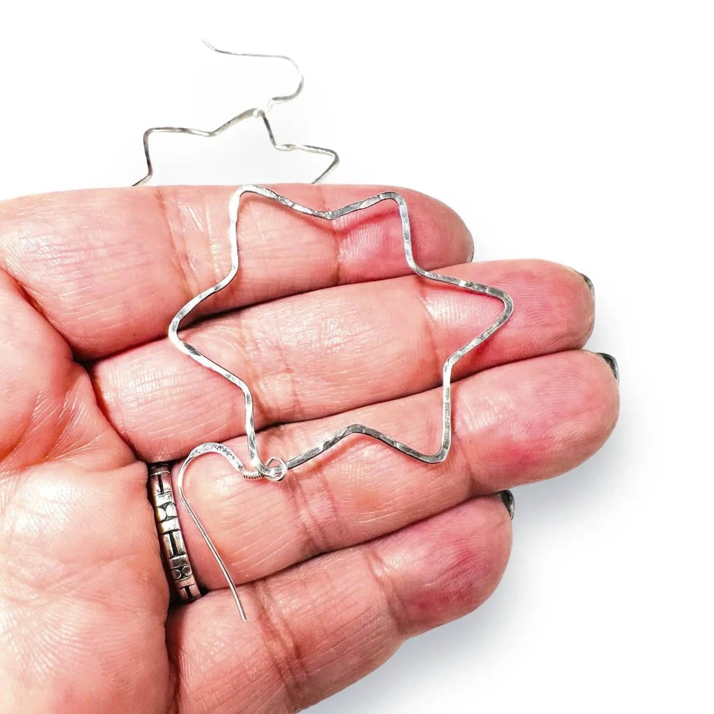 Close-up of Sterling Silver Star Hoops showing size and detail, 2-inch lightweight earrings with hammered star design.