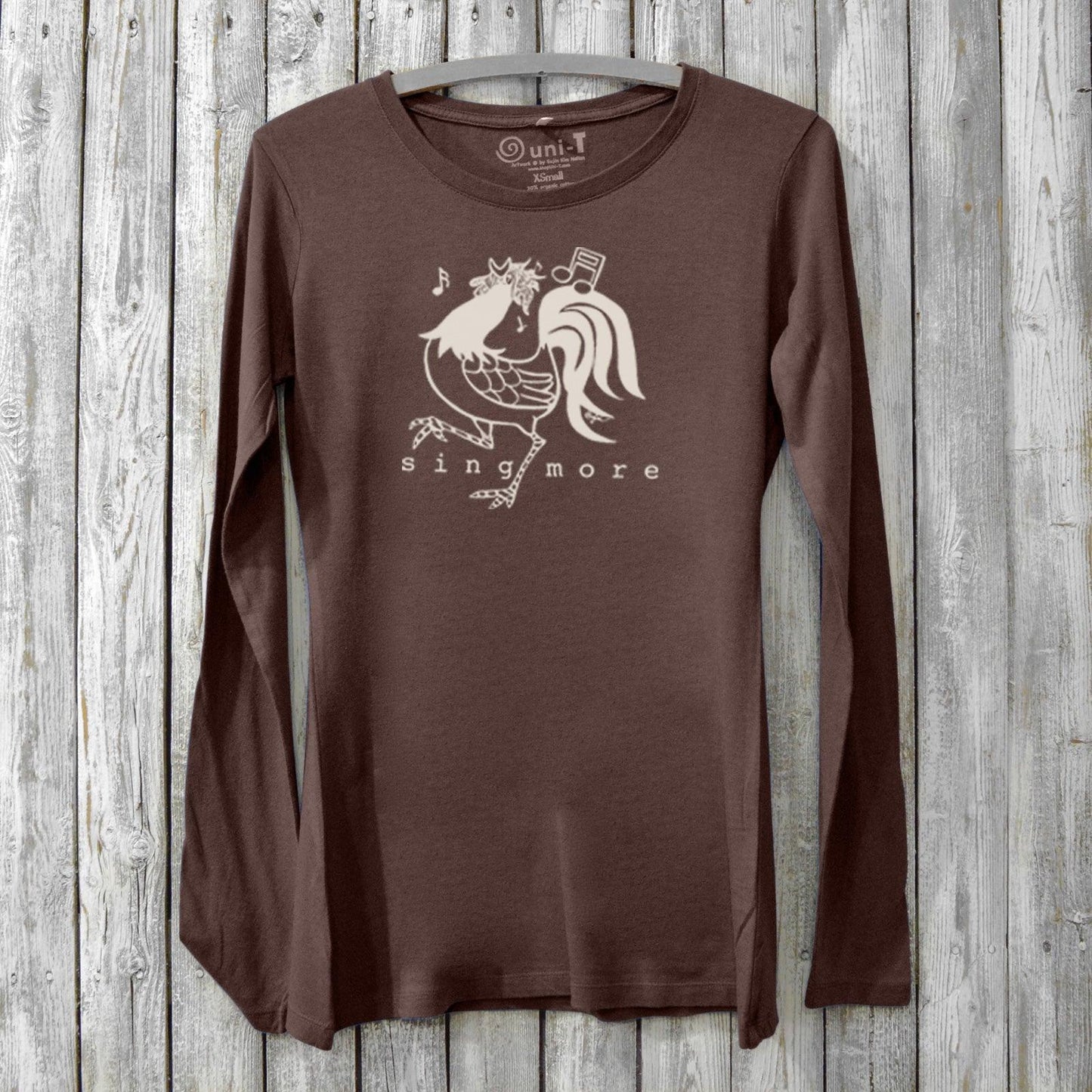 Sing More Women's Bamboo Long Sleeve T-Shirt in dark brown with rooster graphic and musical notes. Eco-friendly organic cotton blend for music lovers.