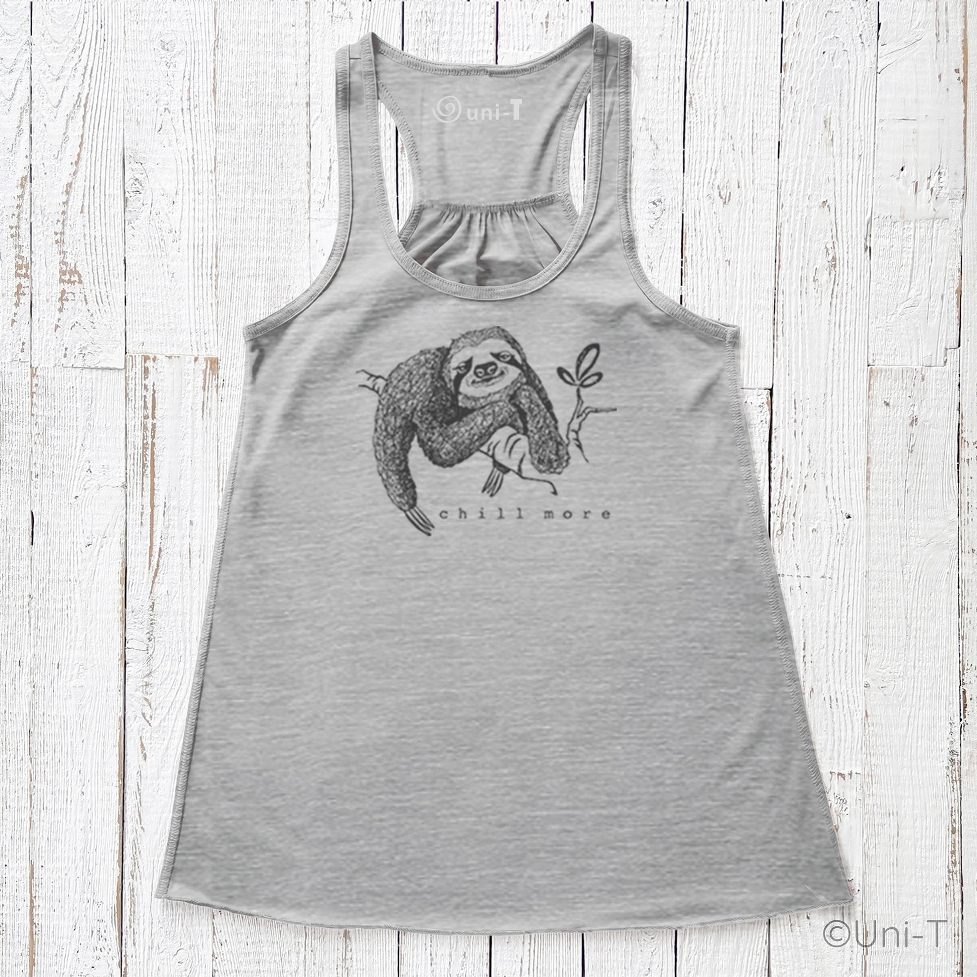 "Chill More" Women's Flowy Tank Top in light grey, racerback cut with mindful sloth design, perfect for relaxed, eco-friendly fashion lovers.