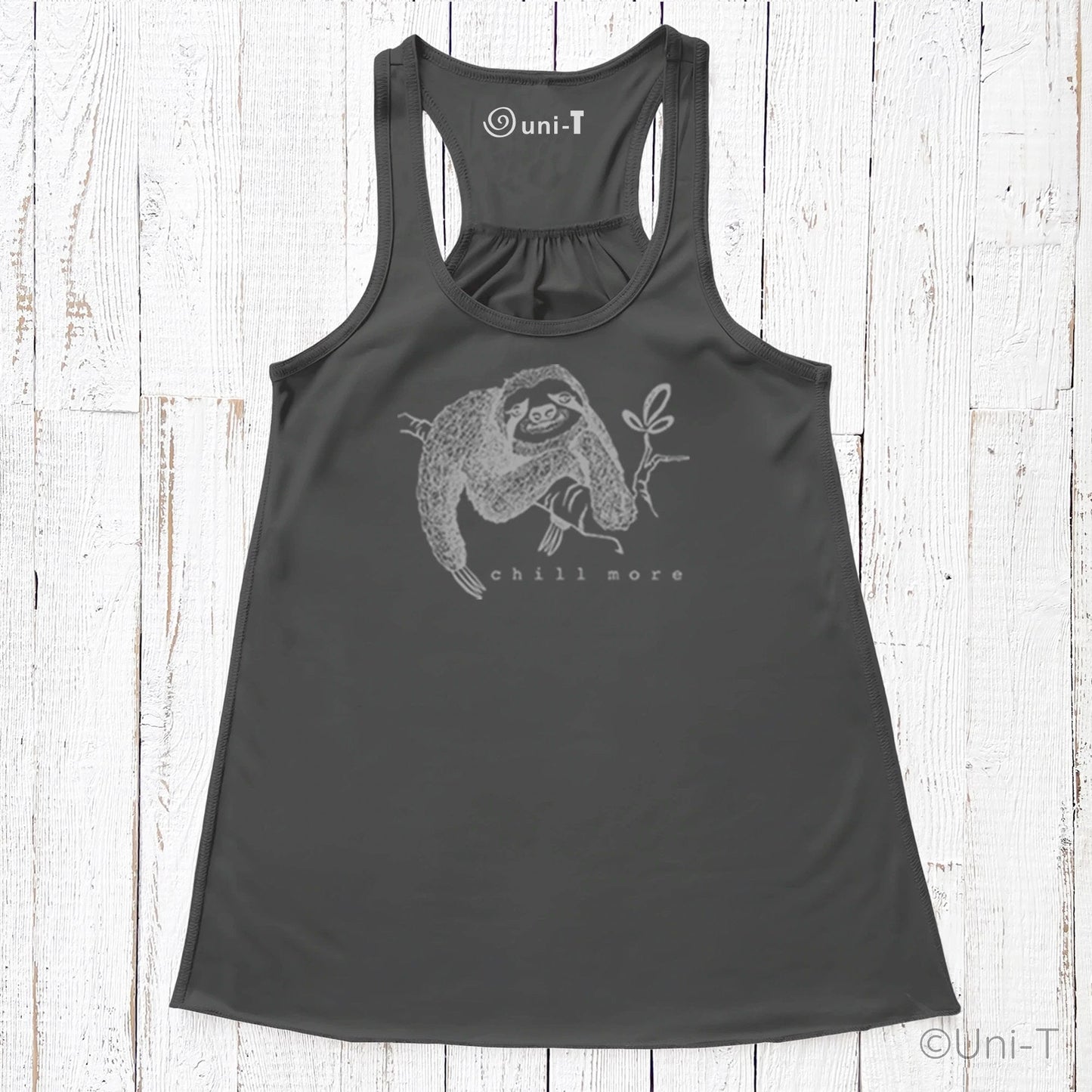 "Chill More" Women's Flowy Tank Top in charcoal black, featuring a sloth holding a leaf, ideal for slow living and sustainable wardrobe choices.