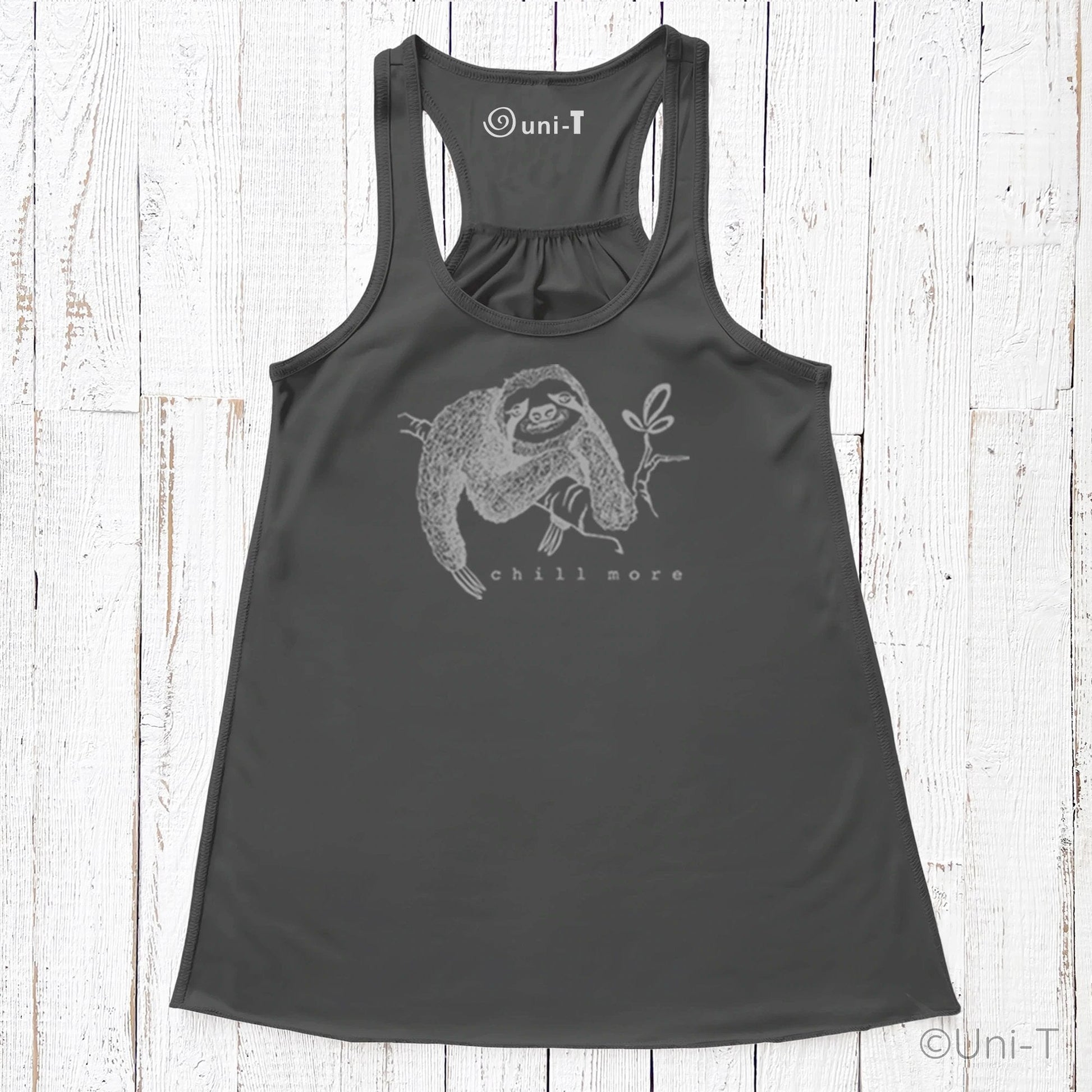 "Chill More" Women's Flowy Tank Top in charcoal black, featuring a sloth holding a leaf, ideal for slow living and sustainable wardrobe choices.
