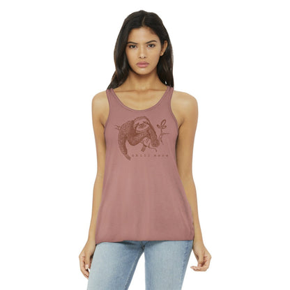 Model wearing "Chill More" Women's Flowy Tank Top in mauve, showcasing soft fabric and sloth graphic for a mindful, casual lifestyle look.