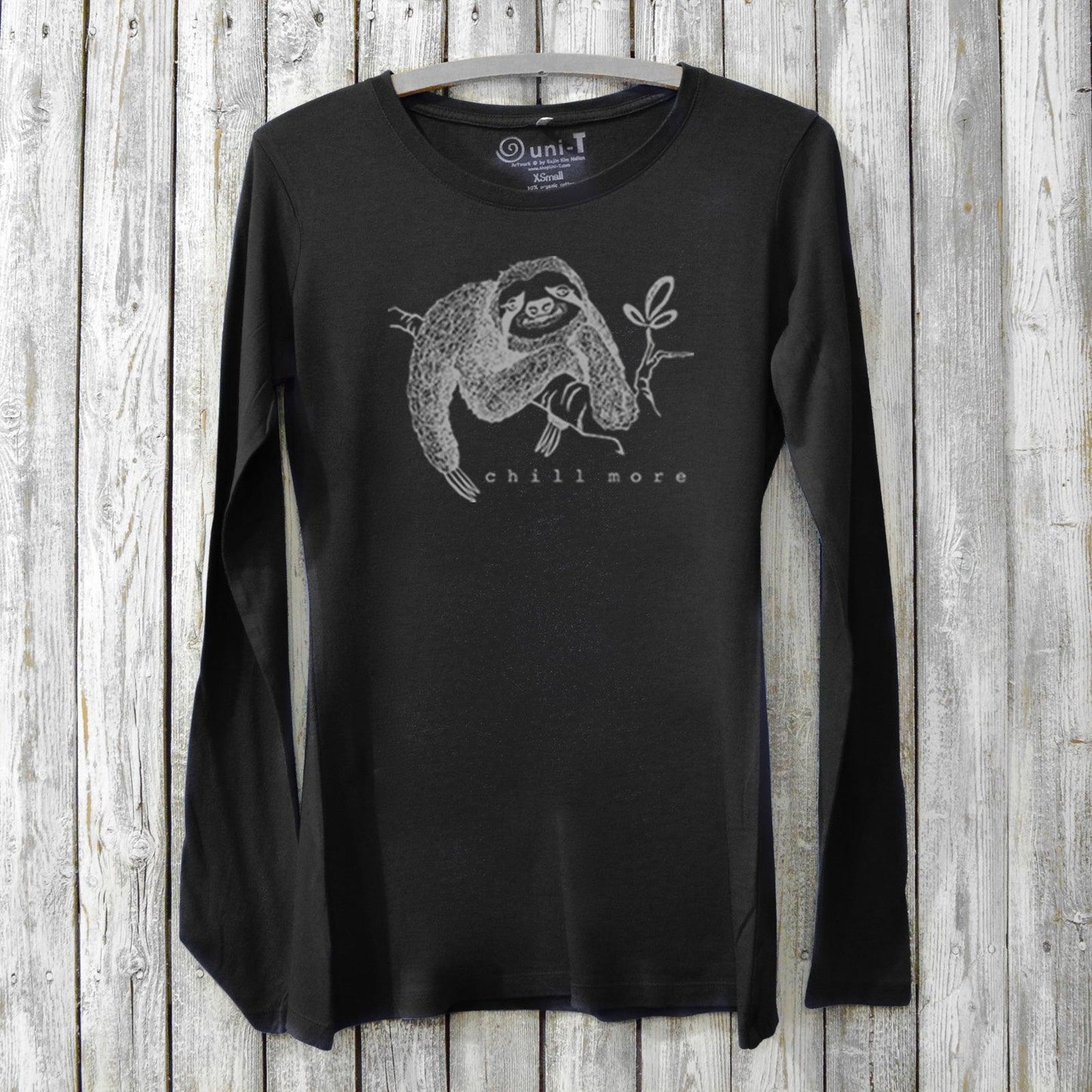 Black women's bamboo and organic cotton long sleeve tee featuring a sloth and 'Chill More' text. Soft, sustainable graphic shirt for relaxing days.