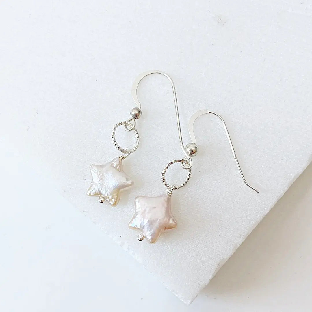 Star Pearl Earrings with white freshwater pearls and sterling silver wire wrapped hooks. Elegant accessory for formal and casual wear.