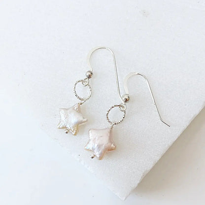 Star Pearl Earrings with white freshwater pearls and sterling silver wire wrapped hooks. Elegant accessory for formal and casual wear.