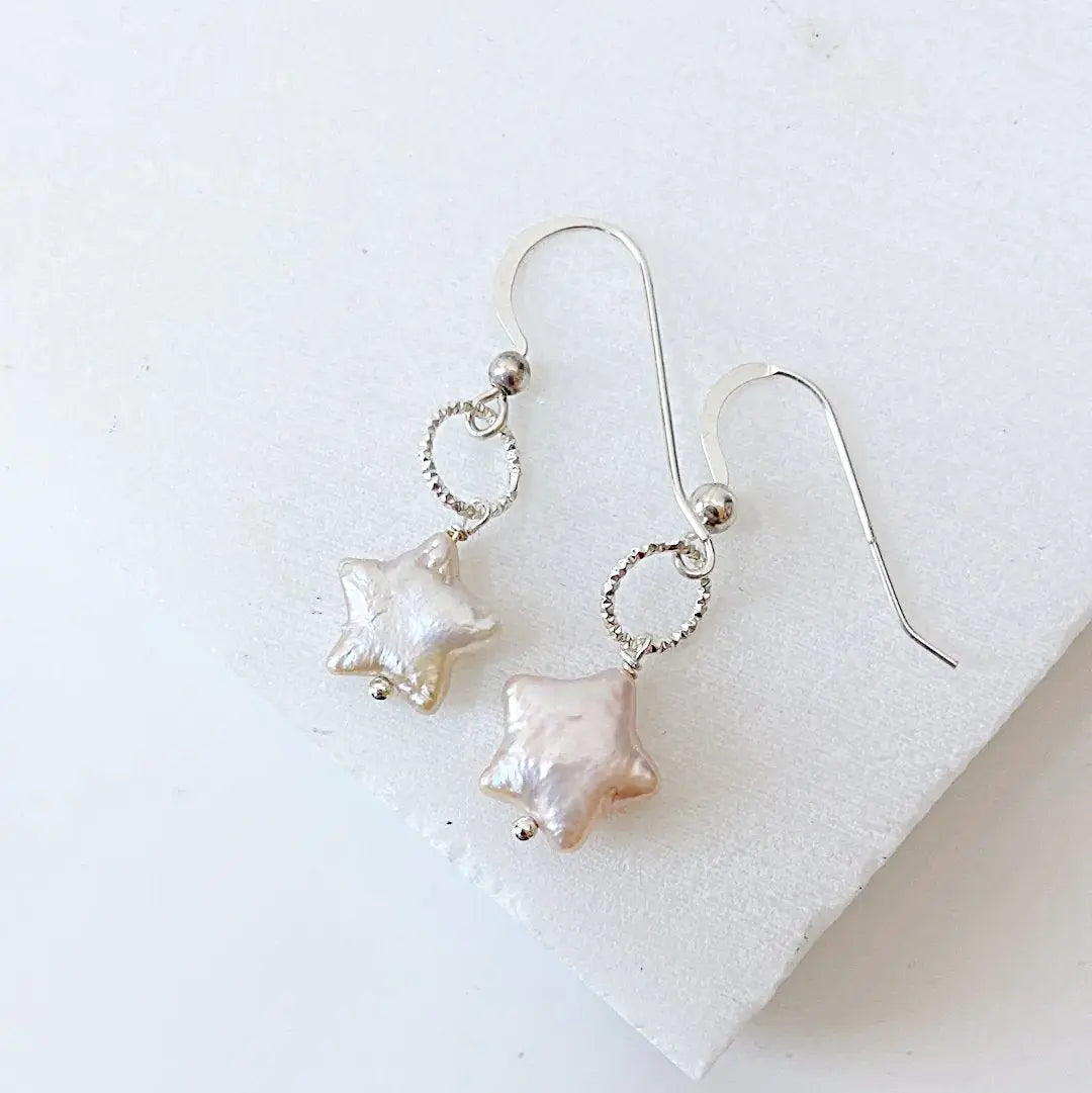 Freshwater pearl star earrings in white with sterling silver twisted loop design. Lightweight and stylish for everyday elegance.