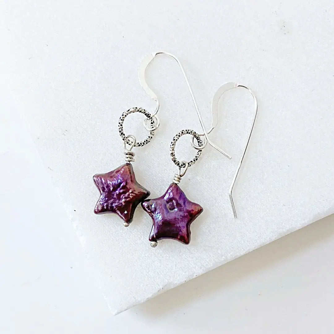 Purple star pearl earrings with sterling silver wire wrapped loops. Unique handcrafted accessory for bold fashion statements.