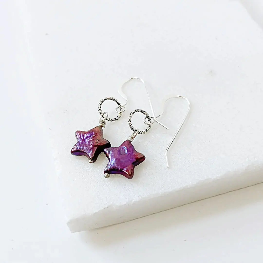 Sterling silver earrings with deep purple freshwater star pearls. Eye-catching and artistic design for special occasions.