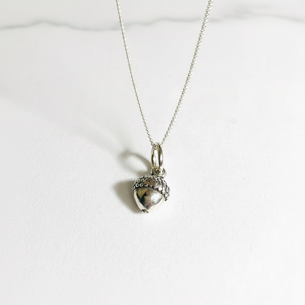 Tiny acorn charm necklace in sterling silver with a 16-inch chain, perfect fall accessory for nature lovers and gift giving.