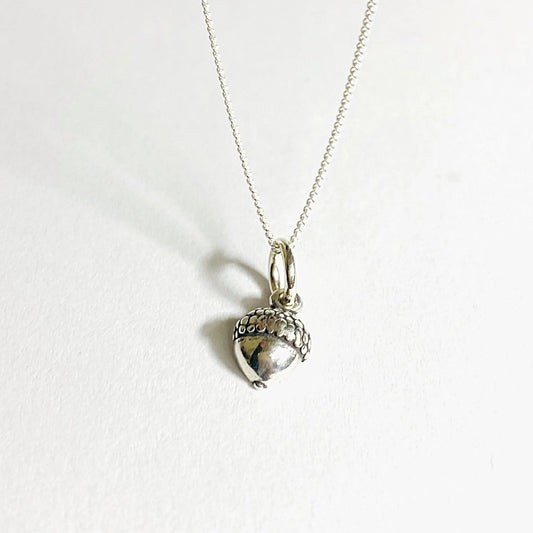 Tiny acorn charm necklace in sterling silver with a 16-inch chain, perfect fall accessory for nature lovers and gift giving.
