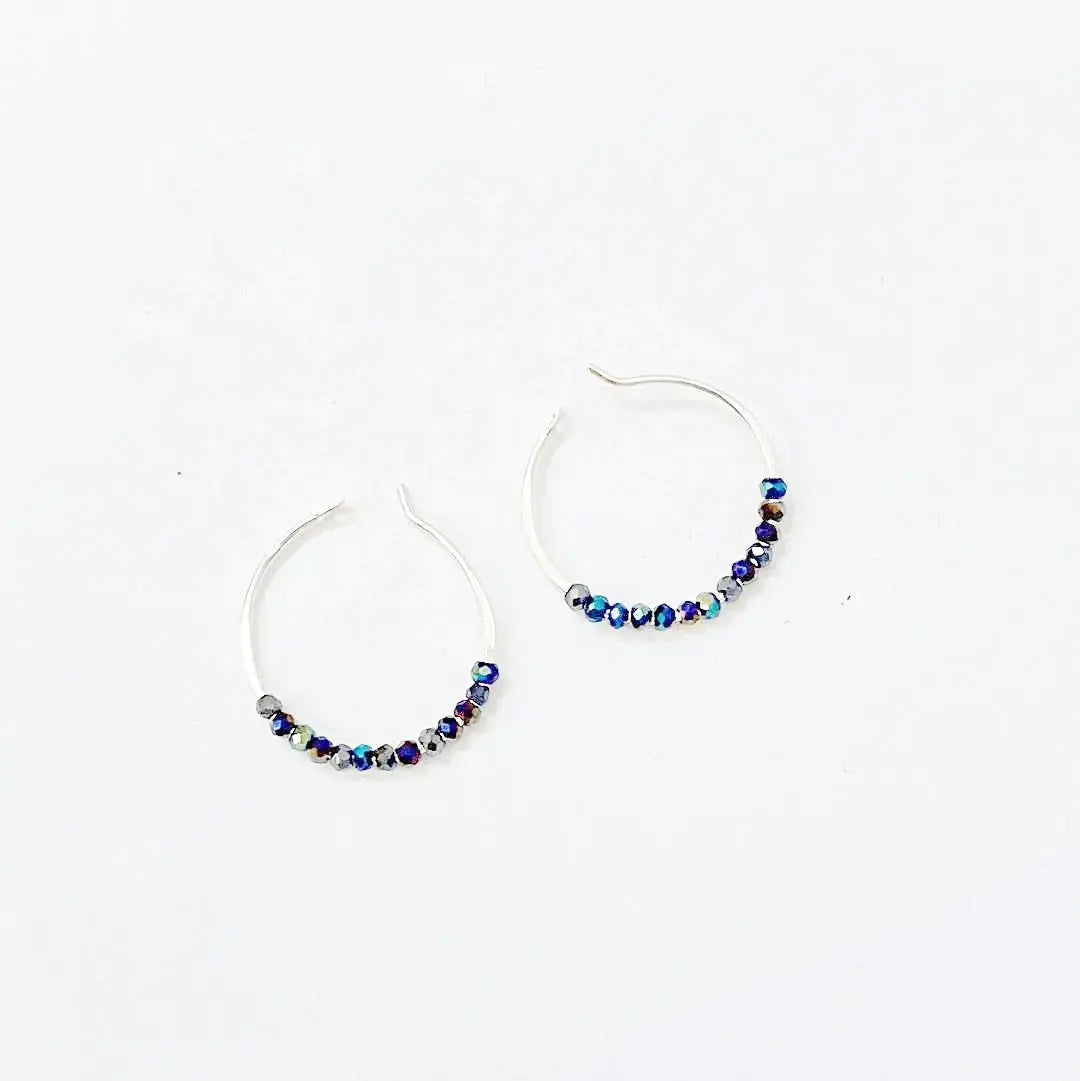 Tiny crystal hoops with electric blue beads on 1" sterling silver hoops. Elegant blue crystal hoop earrings for stylish everyday wear.