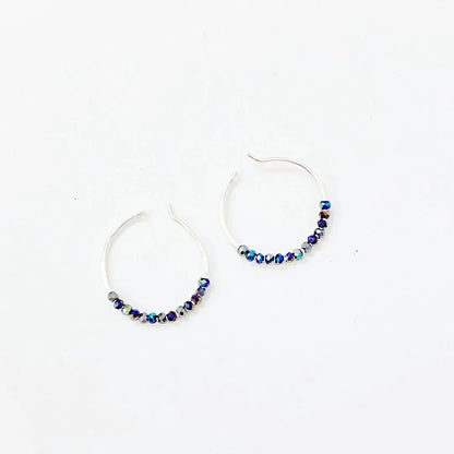 Tiny crystal hoops with electric blue beads on 1" sterling silver hoops. Elegant blue crystal hoop earrings for stylish everyday wear.