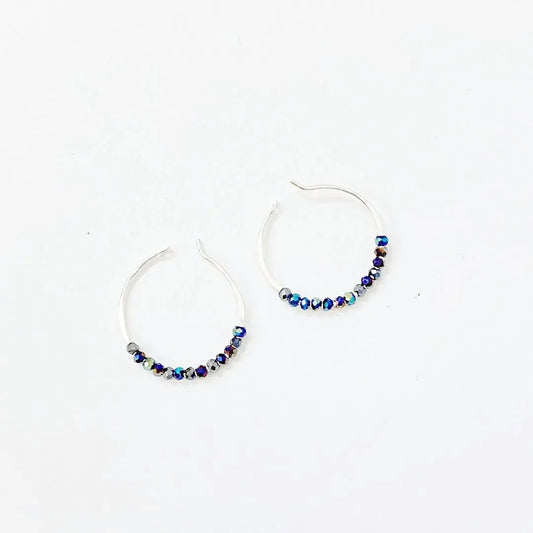 Tiny crystal hoops with electric blue beads on 1" sterling silver hoops. Elegant blue crystal hoop earrings for stylish everyday wear.