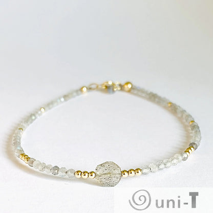 Moonstone Sparkle Bracelet with delicate gold beads and a labradorite focal bead, 7.5” length. Elegant accessory for refined everyday wear.