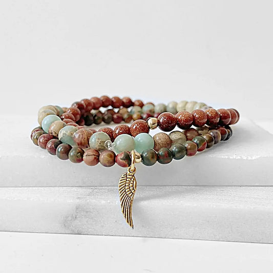 Triple Bracelet Stack - Stylish Beaded Set with Ocean Jasper, Goldstone, and forest jasper beads, accented by a brass wing charm.