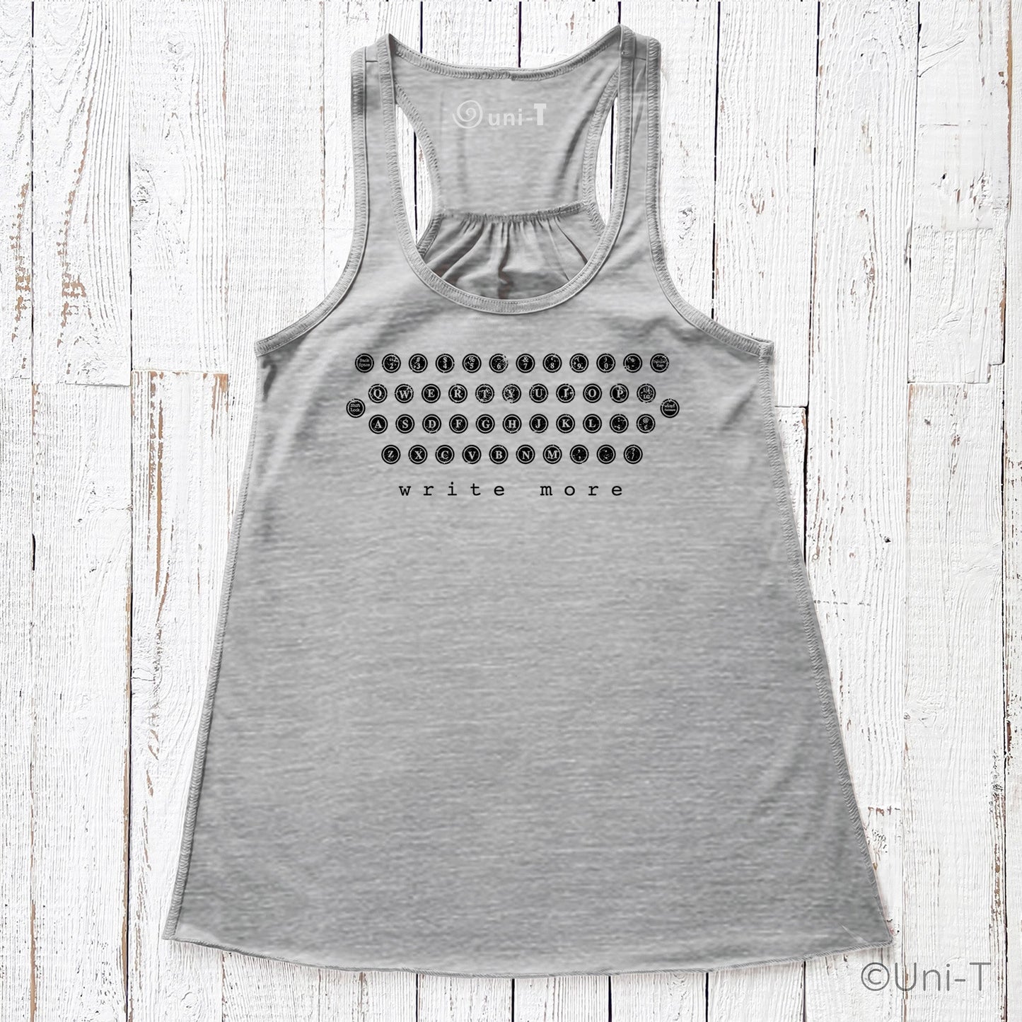 Heather gray "Write More" flowy tank top featuring eco-friendly ink and a retro typewriter layout. Lightweight and perfect for literary lovers.