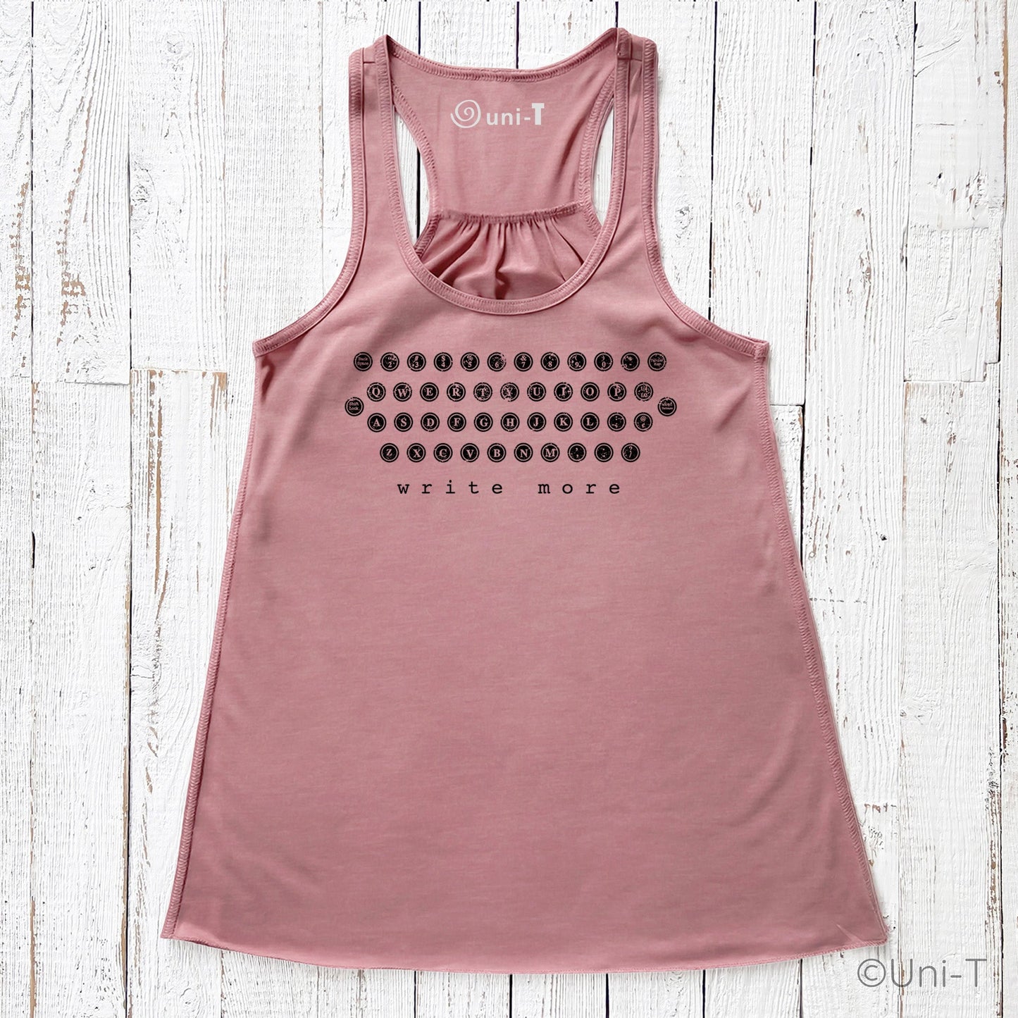 Dusty rose "Write More" tank top with vintage typewriter design. Flowy fit and soft fabric blend for creative comfort.